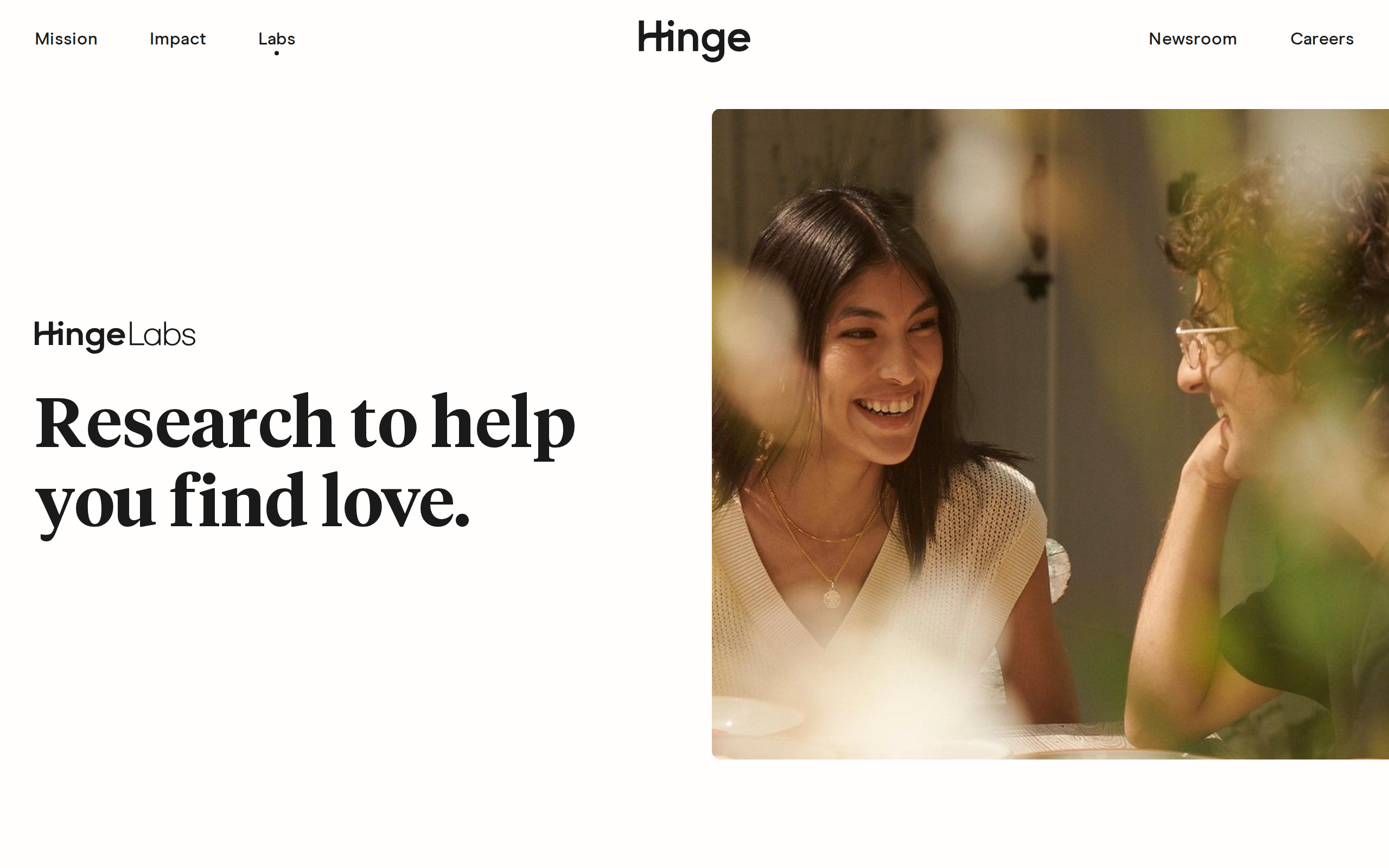 Hinge Labs page on the Hinge website with the headline Research to help you find love next to a photo of two people laughing across a dinner table